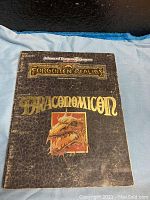 Front cover of the Draconomicon book showing the title and dragon illustration.