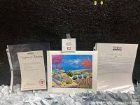 Photo of the signed lithograph alongside Certificate of Authenticity and an information sheet about the artist and artwork.