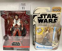 Star Wars Poe Dameron die cast figure in red Disney Elite Series box and Clone Wars Anakin Skywalker figure in blister packaging