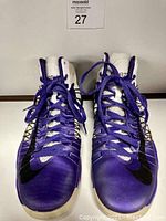 Front view of the purple and white NikeID Hyperdunk 1984 Corzo sneakers with black Nike swoosh and purple laces.