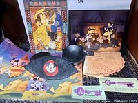 Lot contents showing the vintage Disneyland Mickey Ears hat, multiple Disney color prints, B coupons for rides and Magic Key coupons tickets.