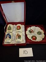 Photo of the boxed set including 4 Christmas-themed porcelain mugs and the Christmas-themed shaped nut dish.