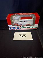 Front view of the I.D.A Guardian 1936 Ford panel truck diecast model in original red box with clear window, showing truck details and branding.