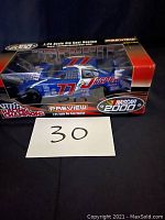 View of the die cast car in original box from front showing packaging and car details.