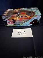 Front and side view of the limited edition Kodak Max NASCAR 2000 1:24 die cast race car inside original packaging marked with NASCAR and Kodak logos.