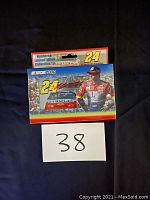 Front of collectible tin showing Jeff Gordon, No. 24 Dupont race car, and NASCAR branding with 'Numbered Limited Edition Collectible Tin' label.