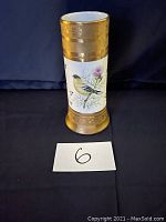 Front view of the Limoges bird vase showing single bird illustration and gold decorative bands.