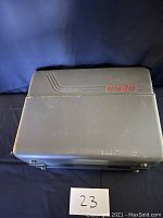 Closed RCA branded hard plastic carrying case in gray with red RCA logo