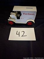 Side view of the white Fordson Iron Bank replica showing 'Fordson No. 2' on the side and red wheels.