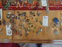 Overview of table with all necklaces, earrings, pendants, ring and beads