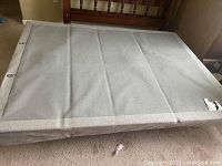Top view of grey upholstered queen-size platform bed frame