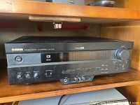 Front and angled view of black Yamaha Natural Sound AV Receiver HTB-5440 showing control knobs and input/output ports.
