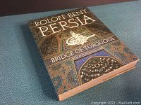 Front cover of the book showing colorful architectural patterns with gold text title and author's name.