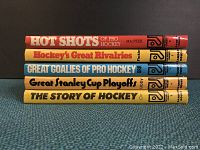 Spine view of 5 Pro Hockey Library books showing titles and authors.