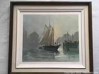Framed lithograph showing a schooner returning to Peggys Cove harbor with dock and foggy background.