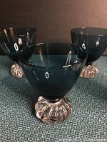 Close-up of one teal crystal liquor glass showing bowl and clear ribbed round base