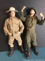 Front view of two GI Joe figures on display: Mountie and US soldier