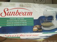 Original box of Sunbeam Mixmaster stand mixer with graphic and logo.