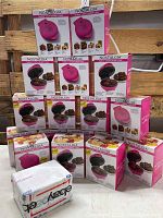 Stack of 18 boxed Nostalgia MyMini Lava & Bundt Cake makers with a USPS flat rate envelope in front