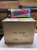 Case of 20 Fast Finger keyboards with one keyboard box displayed on top showing branding and keyboard image covering the full keyboard with black and red color scheme.