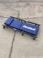 Top angle view of the Duralast mechanics creeper showing the padded sections and caster wheels.