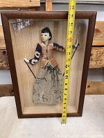 Frontal view of the shadowbox with the doll mounted inside, showing approximate height with measuring tape.