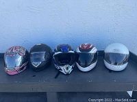 All five helmets lined up showing variety of styles and colors
