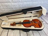 Full view of Cecilio CVN-200 violin in open plush-lined black hard case with two bows inside.
