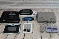 Group shot: Sega Genesis console, PSP in box, PS1 console, SNES controller, InnoTab 3 S and Nook e-reader