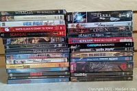 Photo of entire DVD lot stacked showing all 28 DVD cases in shrink wrap