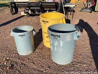 Three Rubbermaid Brute garbage cans, one yellow 44 gallon can with crack and two gray cans in 20 and 32 gallons
