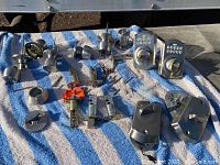 Overall view of assorted Schlage door knobs, deadbolts, latches, and mounting hardware laid out on a cloth.