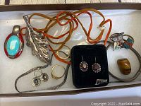 Overview of sterling silver jewelry including leaf pendant, turquoise rings, earrings, necklace, and more