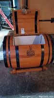 Barrel cooler front view with lid open showing wood exterior and black metal bands
