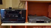 All three audio/video components on shelf: top Marantz receiver, below Sony CD changer, right Zenith DVD player
