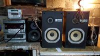 Wide view of Daewoo stereo stack and Yamaha pair of speakers on table in garage