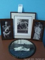 Four framed royalist themed wall art pieces displayed together on a blue wall