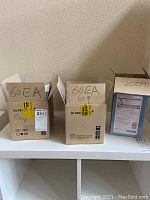 Three open cardboard boxes labeled with quantities 60EA, 60EA, 20EA of face masks.
