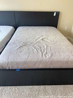 Full front view of the black wood grain double size platform bed with mattress, showing headboard and footboard.