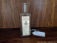 Front view of the antique glass bottle showing original paper label with portrait of Dr. Chase and product name.