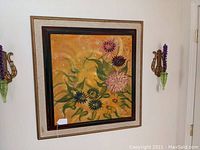 Photo of mid-century framed floral oil painting, showing full frame and wall sconces.