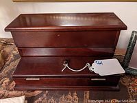 Closed view of the mahogany desktop stationary box showing polished finish and drawer with knob.