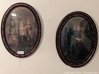 Pair of oval wooden frames with convex glass on a wall showing ancestral portraits