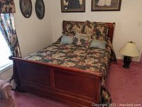 Full view of queen sleigh bed with bedding