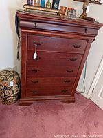 Full view of six-drawer dresser showing wood finish and metal drawer handles.