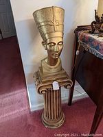 Full view of the bust mounted on the fluted column pedestal in a room corner