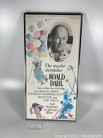 Full view of framed Roald Dahl bookstore poster showing portrait, illustrations and text.