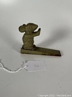 Side view showing mouse figure and doorstop wedge