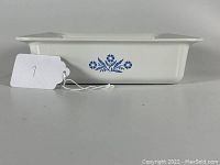Side view of Corning Ware Blue Cornflower baking dish showing floral pattern on white ceramic surface.