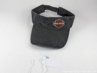 Front view of black denim Harley Davidson visor showing embroidered logo and curved brim.